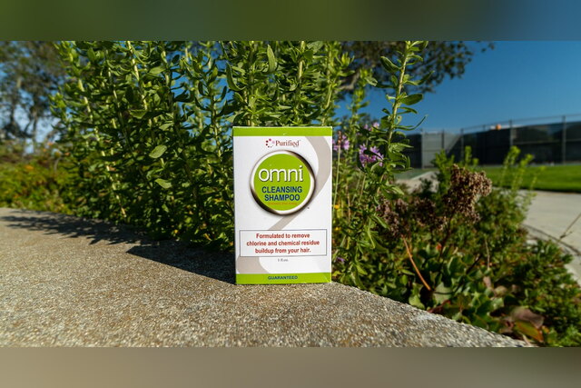 Omni Cleansing Shampoo box on a wall outdoors