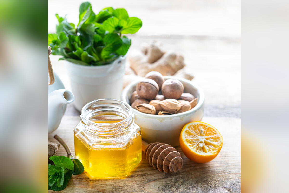 Honey, ginger, lemon and fresh herbs used in alternative medicine