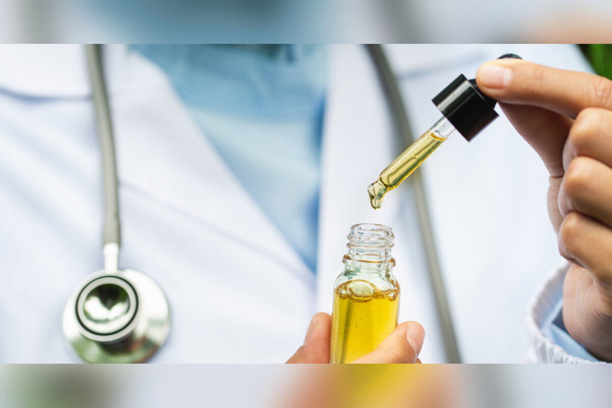 Doctor filling a dropper from a bottle of CBD oil