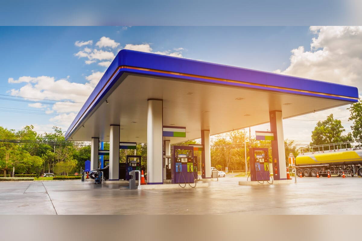 Gas station with fuel pumps under a blue canopy