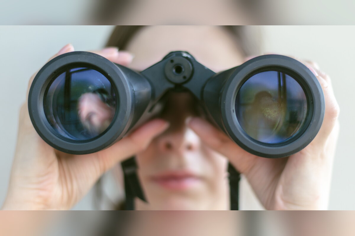 Woman looking through binoculars