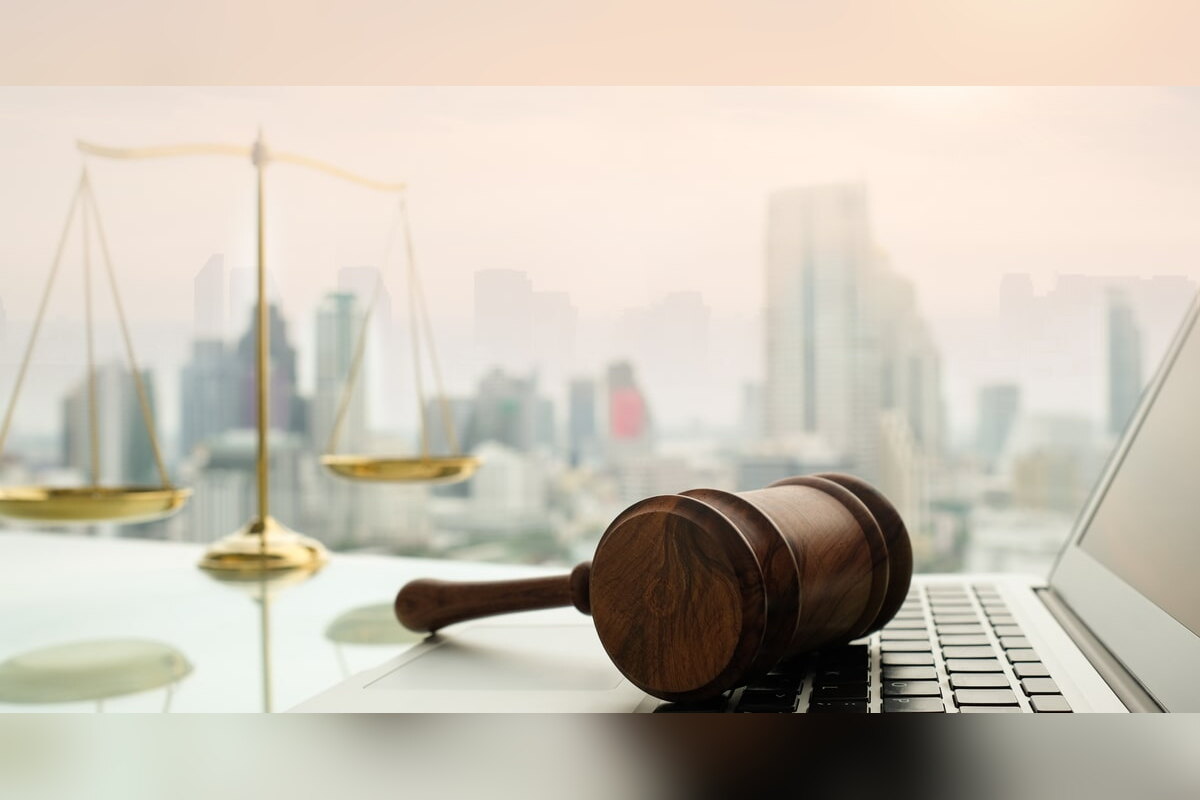 Gavel and scales of justice on a desk overlooking a city skyline
