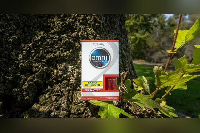 Omni Cleansing Liquid Extra Strength box beside a tree