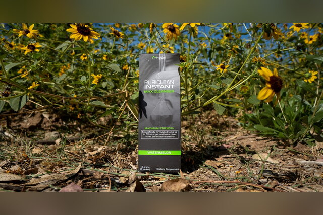 PuriClean Instant Max Cleanser box among yellow flowers