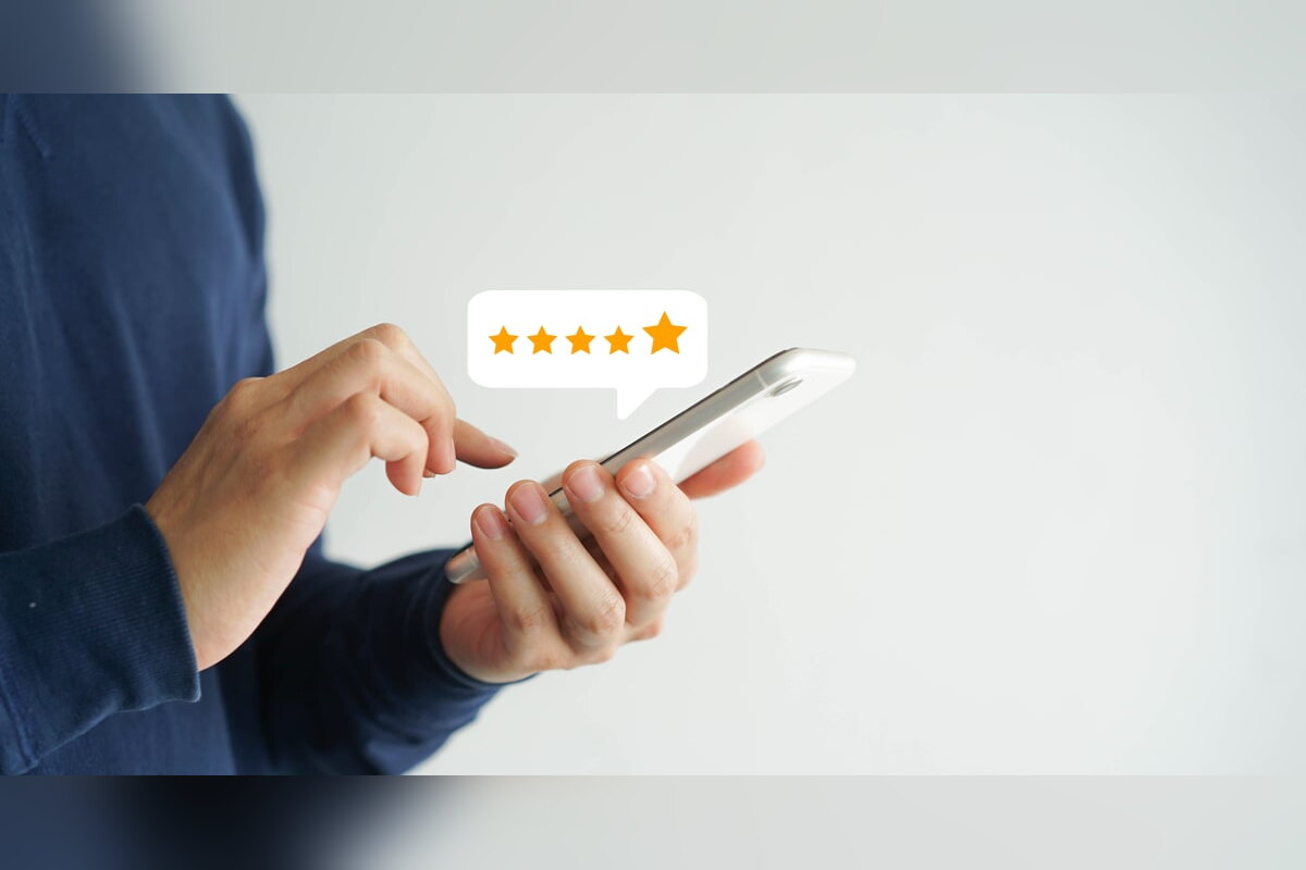 Man rating a product five stars on his smartphone