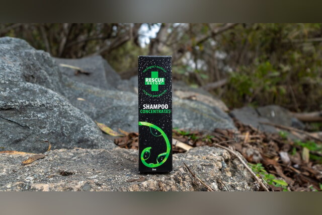 Rescue Detox Shampoo box standing on a rock outdoors